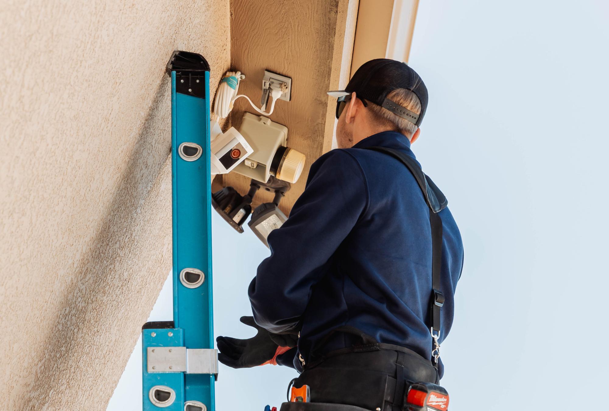 electrician troubleshoots and repairs outdoor lighting