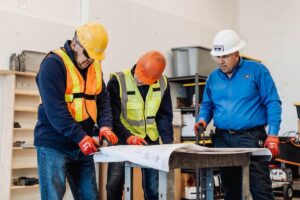 electricians review work plans for home remodel