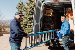 friendly electricians unloading ladder